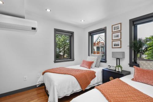 two beds in a room with two windows at 2BR2Bth 2 Parking Spaces,TD Garden,MIT,Harvard,BOS in Somerville