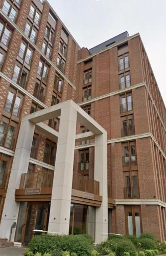 a large brick building in front at Extra large spacious 1 Bedroom private apartment, Nr St Albans City Station, Business, contractor, Parking, WiFi in St. Albans
