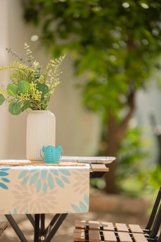 a table with a vase with a plant on it at Trullo Pietra Cannella in Alberobello