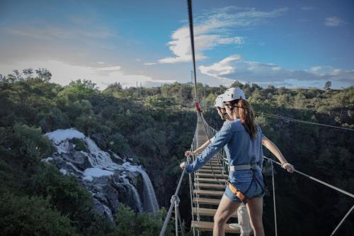a woman on a suspension bridge over a waterfall at Holiday Inn Tlaxcala by IHG in Tlaxcala de Xicohténcatl