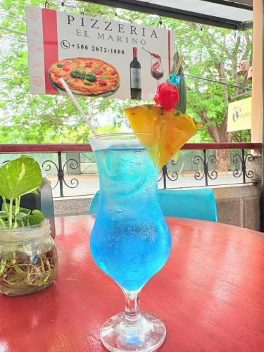 a blue drink with a cherry on a table at Hotel Villa Acacia in Playa Hermosa