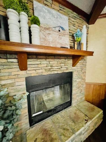 a living room with a stone fireplace at Mark House in Hammond