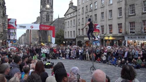 a crowd of people watching a man jumping in the air at Edinburgh Drumdryan Central Apart in Edinburgh