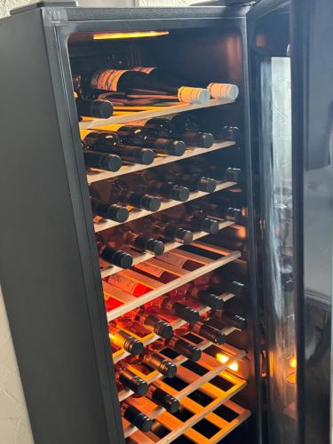 a refrigerator filled with lots of wine bottles at Rheingaulodge -Ihre Auszeit am Rheinsteig in Oestrich-Winkel
