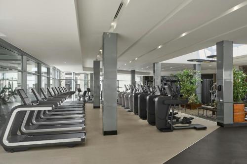 a gym with a row of treadmills at Sheraton Amman Al Nabil Hotel in Amman