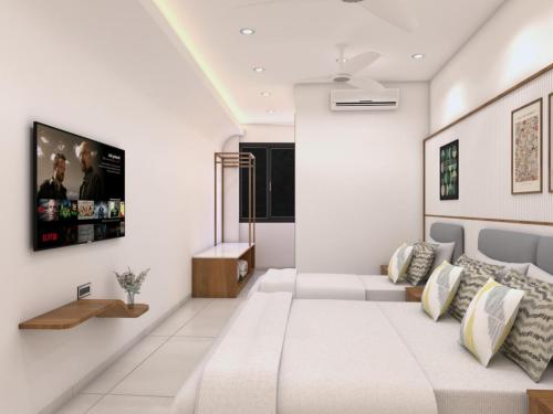 a living room with a couch and a tv on a wall at Radha Ratna Hotel in Ayodhya