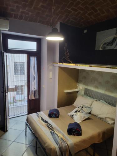 a bedroom with a bed with two hats on it at A casa di ninni ''Ormea room'' in Turin