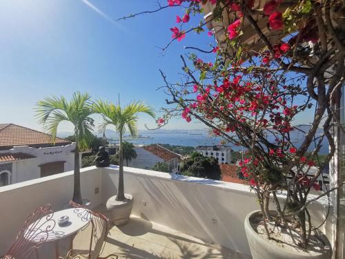 a balcony with palm trees and flowers on a building at Lux 12 - Cobertura Romantica com piscina aquecida e vista mar in Rio de Janeiro