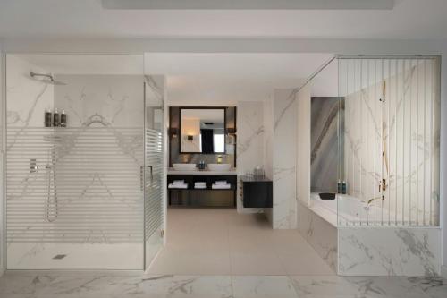 a bathroom with a shower and a sink at Four Points by Sheraton Costa Blanca Resort in Benidorm