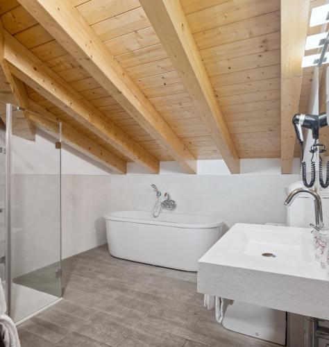 a bathroom with a white tub and a sink at Hotel Venta de Etxalar in Etxalar