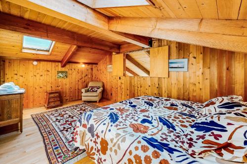 a bedroom with a bed in a room with wooden walls at Cadwalader House in Sea Ranch