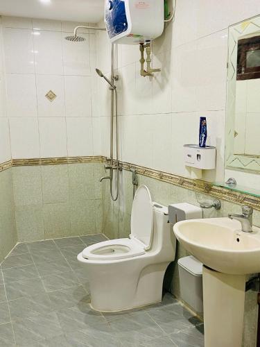 a bathroom with a toilet and a sink at HnH Homestay 2 in Hanoi