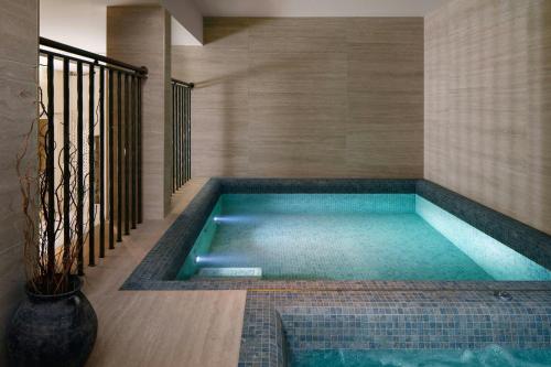 a swimming pool in the middle of a house at Montcalm Mayfair, Autograph Collection in London