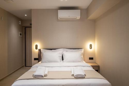 a bedroom with a bed with two towels on it at Agora Views in Athens