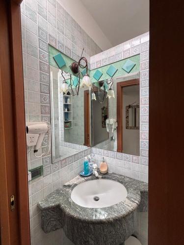 a bathroom with a sink and a mirror at Residenza Borgo Antico in Termoli