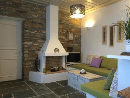 a living room with a couch and a fireplace at Rose Home in Apollonia