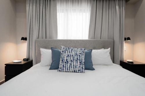 a bedroom with a large white bed with blue pillows at Breakfast included - 2 bedrooms - RL1 707 in La Julia