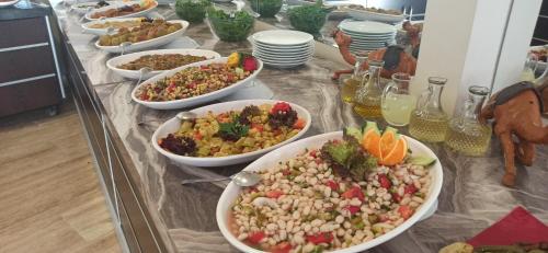 a buffet with many bowls of food on a table at Sare Hotel in Erdek
