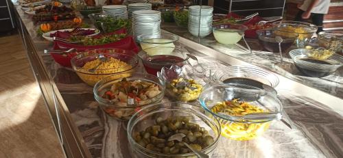 a buffet with many bowls of different types of food at Sare Hotel in Erdek