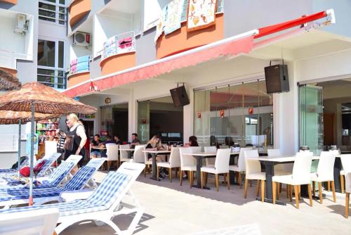 a restaurant with chairs and tables on the beach at Sare Hotel in Erdek