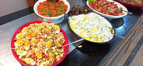 a group of bowls of food on a counter at Sare Hotel in Erdek