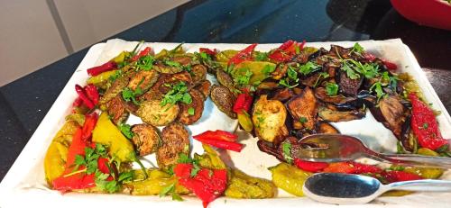 a plate of food with meat and vegetables on a table at Sare Hotel in Erdek