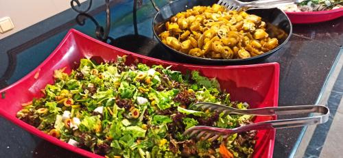 a red tray of food with forks and pasta at Sare Hotel in Erdek