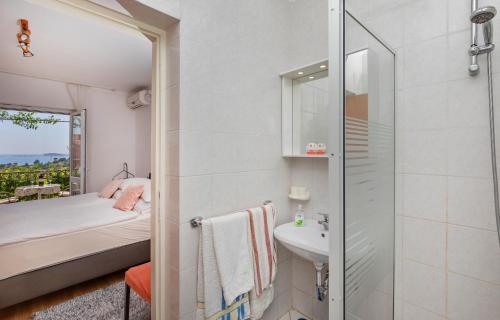 a small bathroom with a sink and a shower at Apartments Galić in Mlini