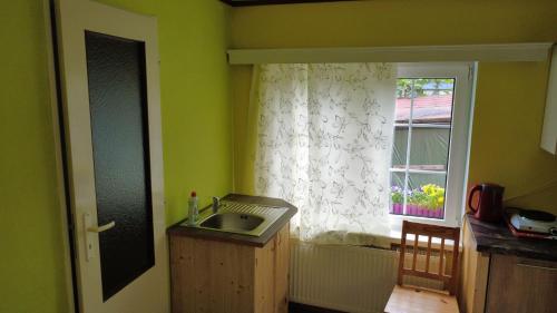 a kitchen with a sink and a window at Pension Euro 2000 in Děčín