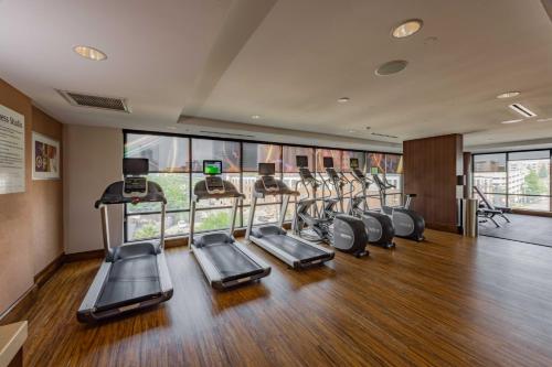 a gym with a row of treadmills and ellipticals at Hotel Indigo Austin Downtown - University by IHG in Austin