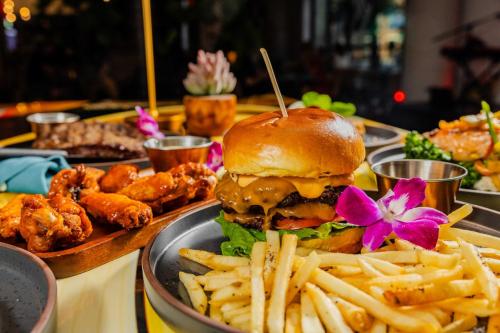 a plate of food with a burger and french fries at Hotel Indigo Austin Downtown - University by IHG in Austin