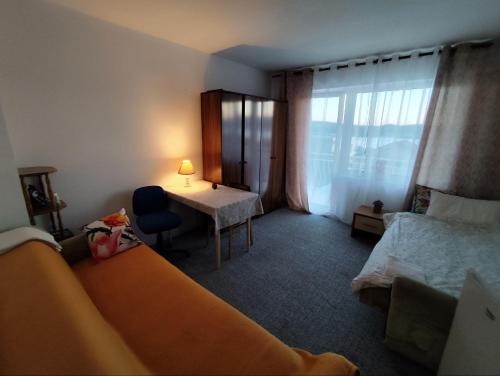 a hotel room with a bed and a desk and a window at Wisteria in Tivat