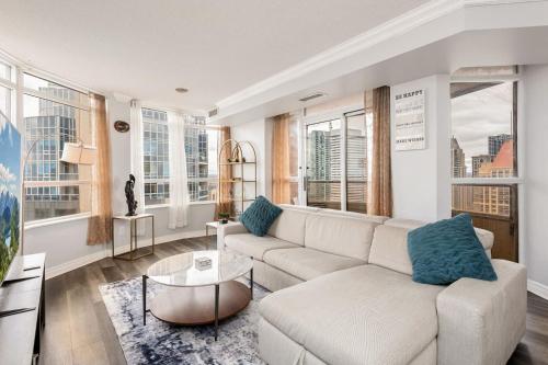 a living room with a couch and some windows at Sky Retreat | 2BR-2BA High Floor | 180° City View in Mississauga