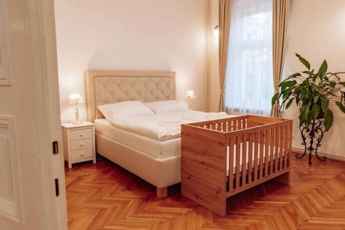 a bedroom with a bed and a potted plant at Aparmány Rozálie in Česká Lípa