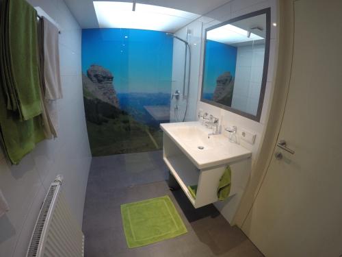 a bathroom with a sink and a mirror at Ferienwohnung Vogt in Mellau