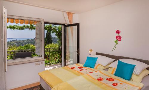 a bedroom with a bed and a large window at Apartments Galić in Mlini