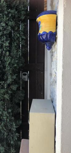 a large vase hanging on the side of a door at Ciboulette in Mirabel-aux-Baronnies