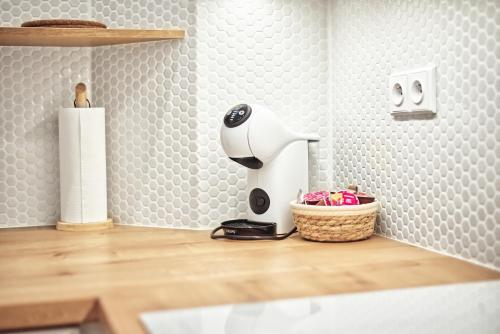 a hair dryer sitting on a counter next to a basket at Apartmány VIENNA in Mikulov