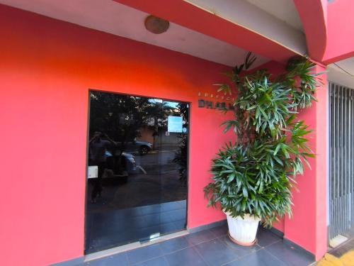 a pink building with a plant in front of it at Dpto a pasos de la playa San José in Encarnación