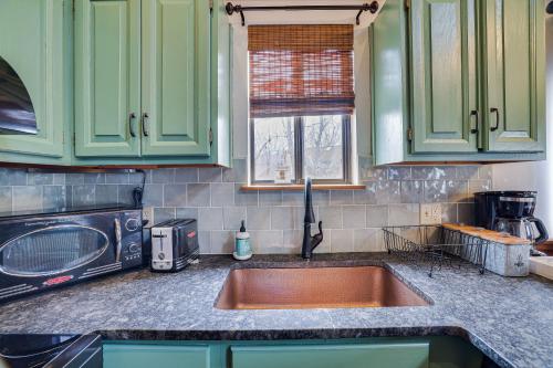 a kitchen with a sink and a microwave at Moose Tracks Cabin Hot Tub 1 Mile To Lake in Lake Harmony