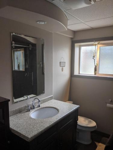 a bathroom with a sink and a toilet at Private SweetSuite 1 Bdrm Bathroom mini-kitchen in Kamloops