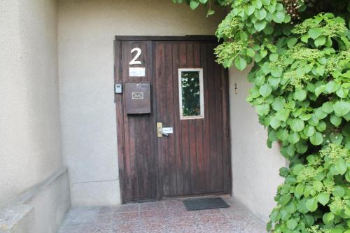 a wooden door with the number two on it at Roheline vaikus in Pärnu