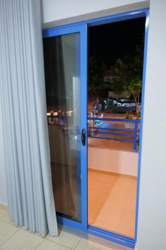 an open glass door with a view of a balcony at 2E Villa & Homestay in Ksamil