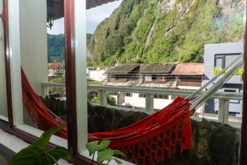 a view from a window with a hammock at Hotel De Mi Pueblo in Baños