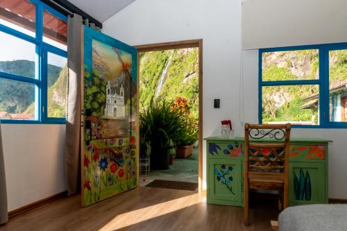 a room with a door and a painting on the wall at Hotel De Mi Pueblo in Baños