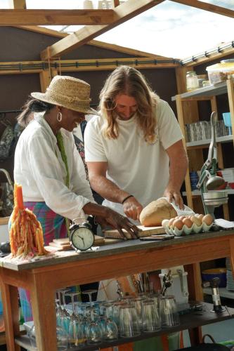 two women standing in a kitchen preparing food at CABRA - Porto Covo in Porto Covo