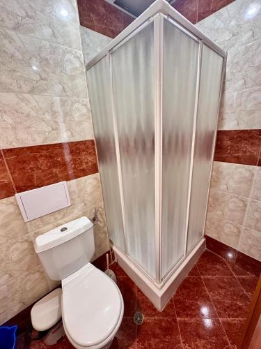 a bathroom with a toilet and a shower at Sveti Vlas Fort Noks Panorama SAS in Sveti Vlas
