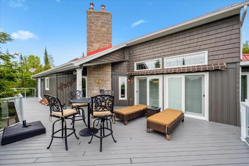 a deck with chairs and a table on a house at 45 Degrees North - Tobermory in Tobermory