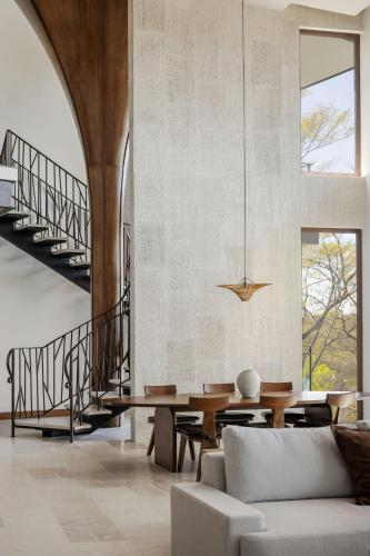 a living room with a table and a staircase at W Costa Rica Resort – Playa Conchal in Playa Conchal