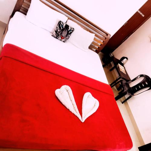 a red bed with a heart painted on it at Coorg Sunway home stay in Madikeri